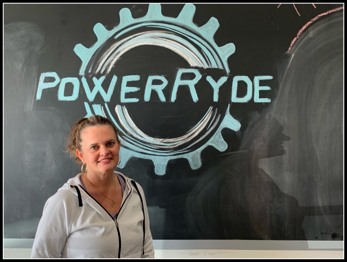 Erin Amundson in front PowerRyde chalk logo